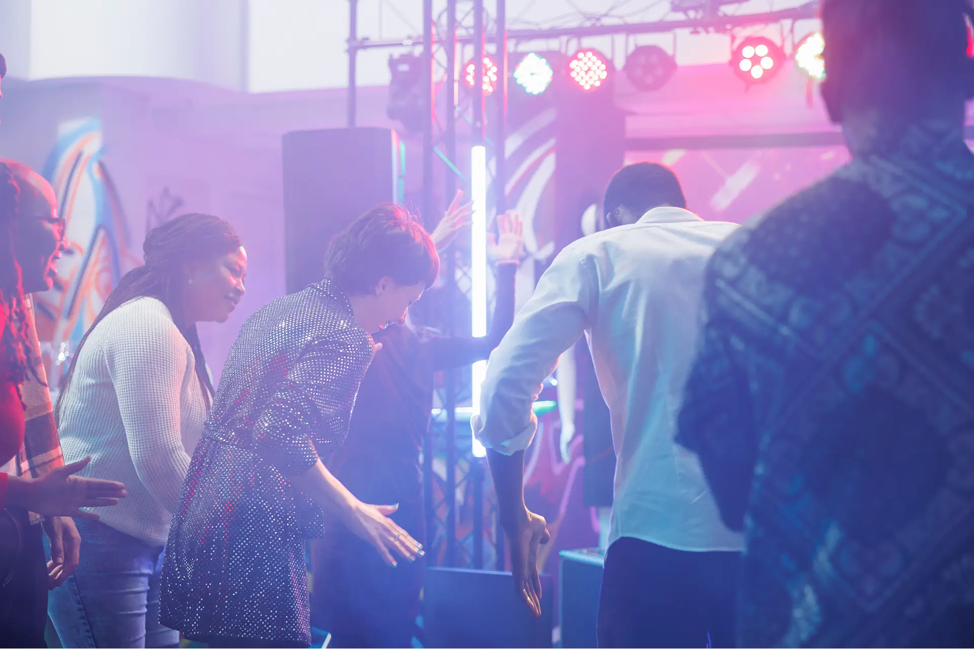 Nail technician applying burgundy polish during a professional pedicure at Aura Day Spa in Thunder Bay.